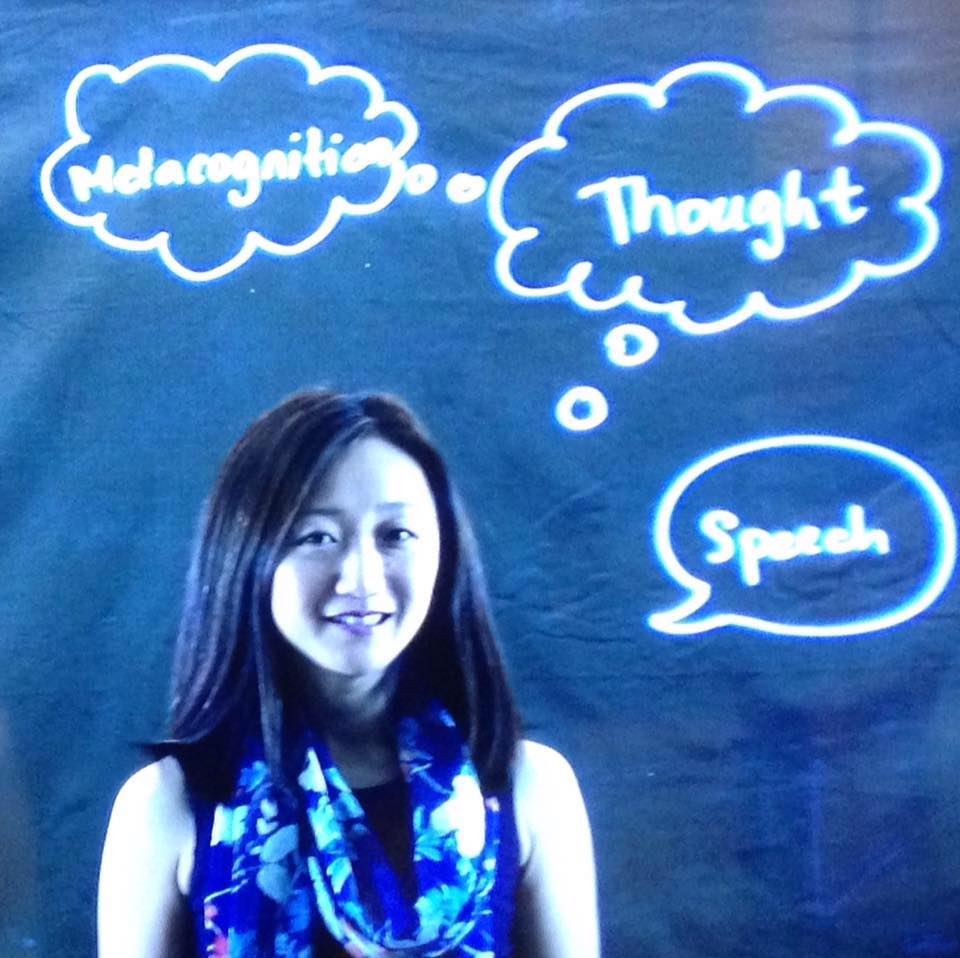 Nobuko behind lightboard with though and speech bubbles